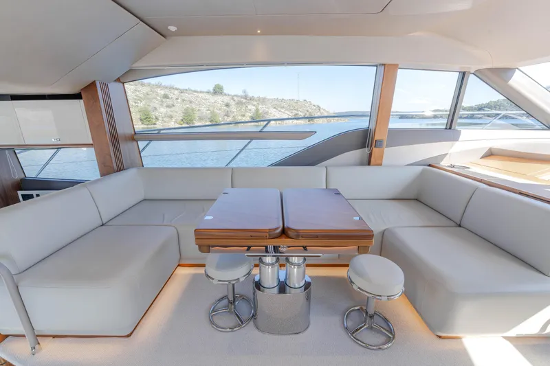 Whiskey Yacht Photos Pics Luxurious interior of 2021 Princess F55 yacht with elegant seating and scenic water view.