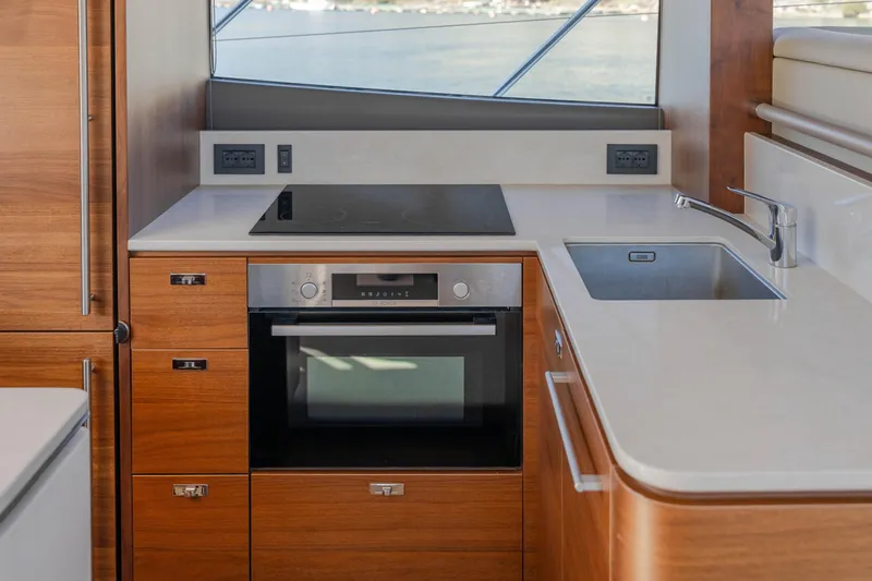 Whiskey Yacht Photos Pics Modern kitchen in 2021 Princess F55 yacht with stove, oven, and sink.
