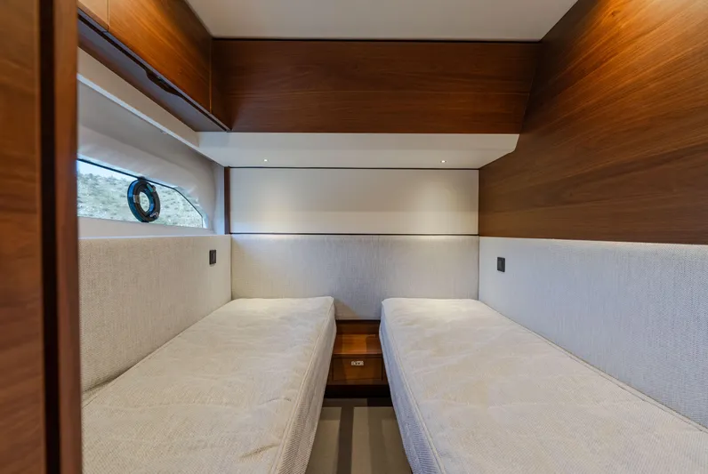 Whiskey Yacht Photos Pics Luxurious twin cabin interior of 2021 Princess F55 yacht with wood paneling.