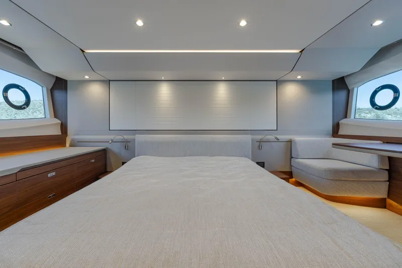 Whiskey Yacht Photos Pics Luxurious bedroom interior of 2021 Princess F55 yacht with modern design and ambient lighting.