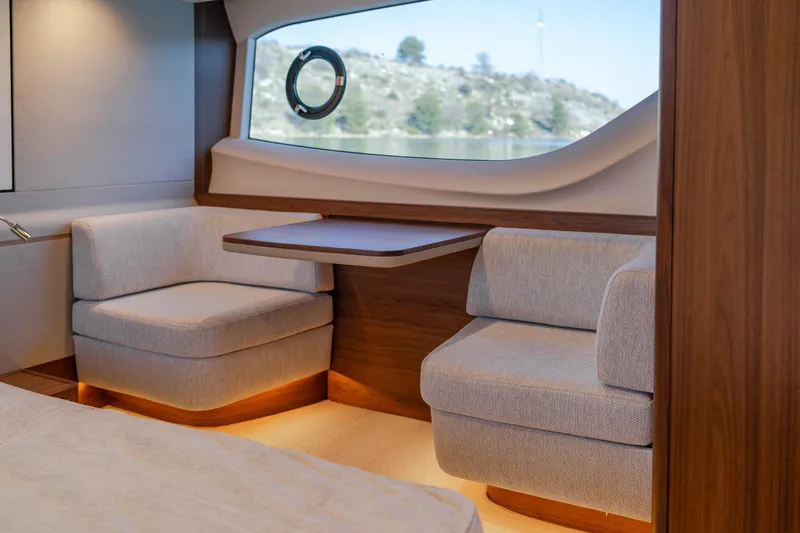 Whiskey Yacht Photos Pics Luxurious 2021 Princess F55 yacht interior with elegant seating and scenic window view.