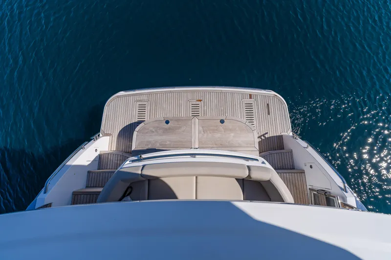 Whiskey Yacht Photos Pics Aerial view of 2021 Princess F55 yacht's deck on clear blue water.