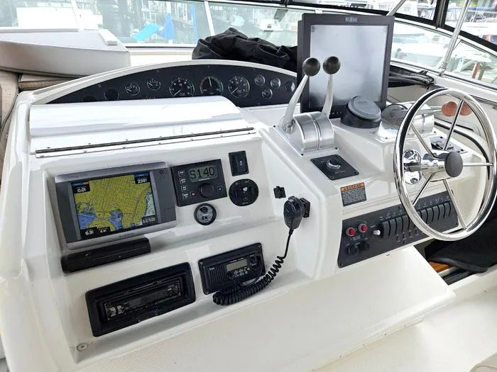  Yacht Photos Pics Control panel of a 2000 Bayliner 5288 Pilot House Motoryacht with navigation equipment and steering wheel.