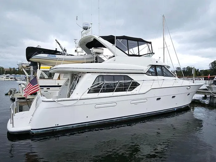  Yacht Photos Pics 2000 Bayliner 5288 Pilot House Motoryacht docked at marina under cloudy sky.