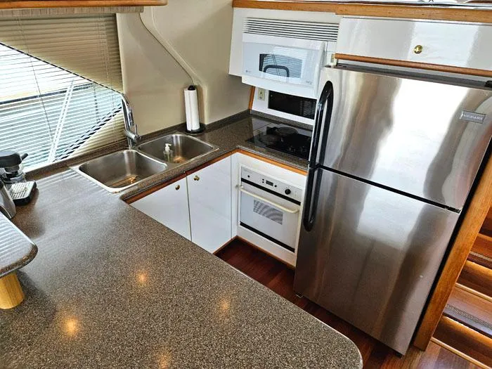  Yacht Photos Pics Modern kitchen in 2000 Bayliner 5288 Pilot House Motoryacht with stainless steel appliances.