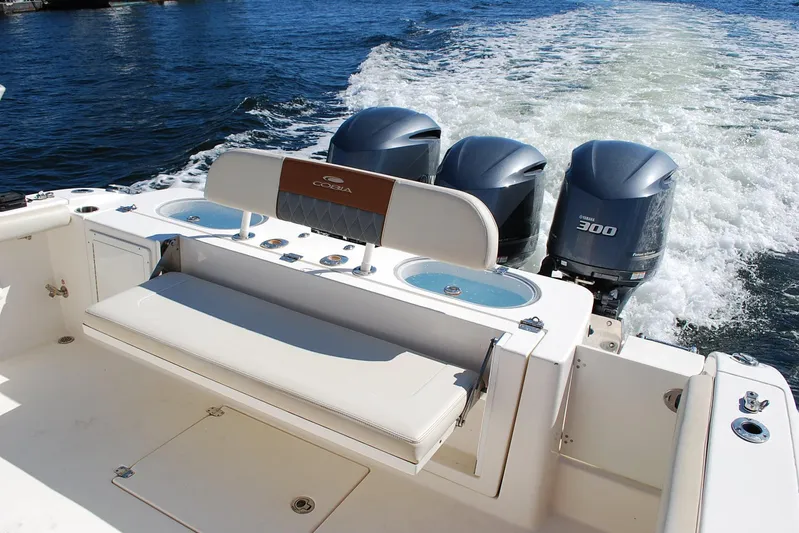 Playin Hooky Yacht Photos Pics 2019 Cobia 344 Center Console boat with triple Yamaha 300 engines on water.