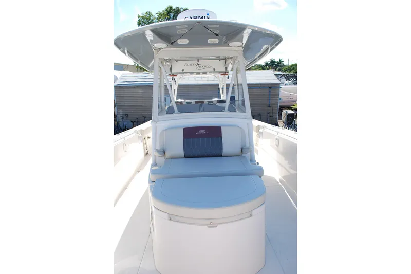 Playin Hooky Yacht Photos Pics 2019 Cobia 344 Center Console boat with seating and canopy, docked outdoors.