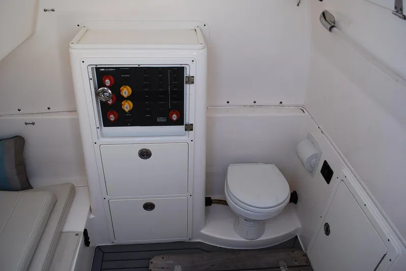Playin Hooky Yacht Photos Pics 2019 Cobia 344 Center Console boat interior with control panel and toilet.