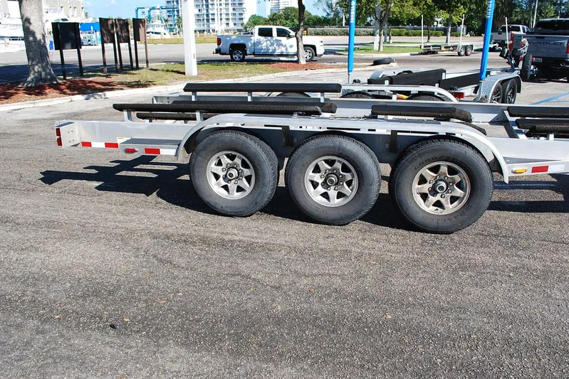 Playin Hooky Yacht Photos Pics Triple-axle boat trailer for 2019 Cobia 344 Center Console in parking lot.