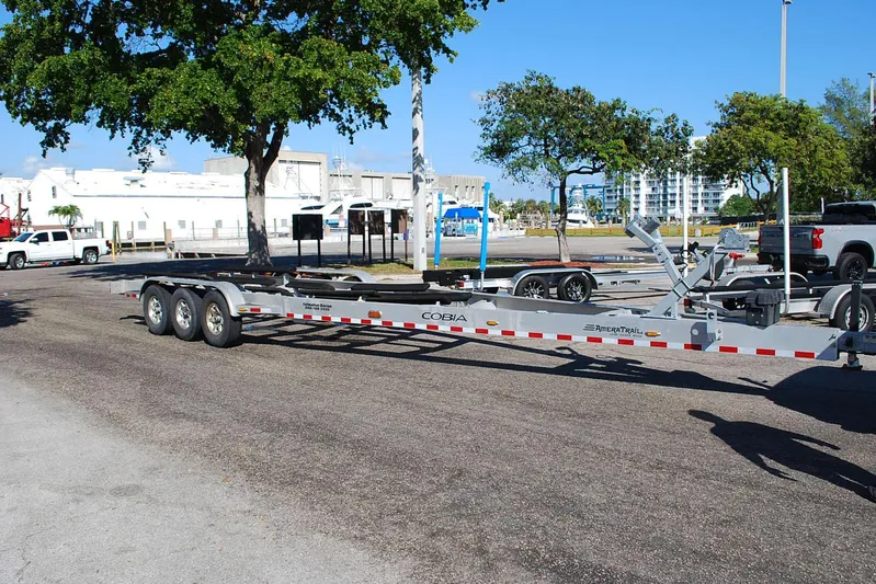Playin Hooky Yacht Photos Pics Trailer for 2019 Cobia 344 Center Console boat parked near trees and buildings.