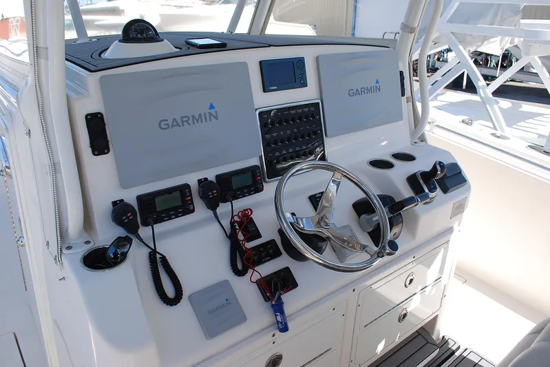 Playin Hooky Yacht Photos Pics 2019 Cobia 344 Center Console helm with Garmin electronics and steering wheel.