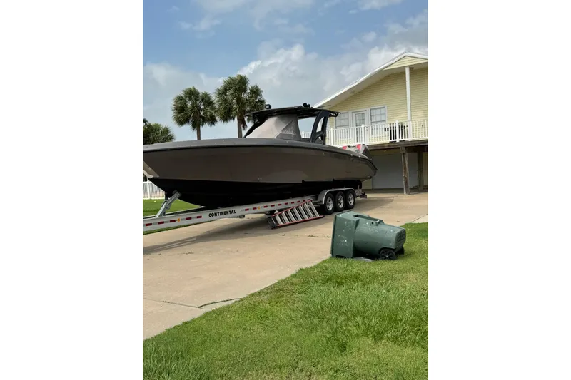 Yacht Photos Pics 2020 Midnight Express 37 Center Console boat on trailer near house.