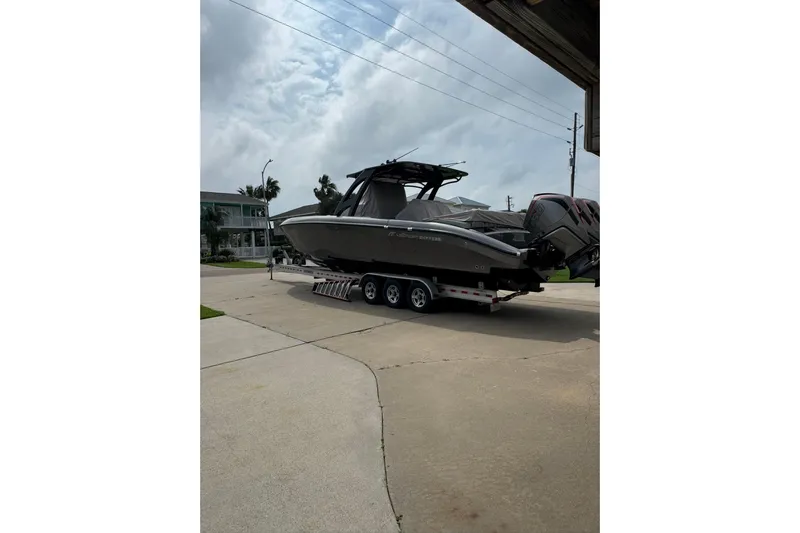  Yacht Photos Pics 2020 Midnight Express 37 Center Console boat on trailer in residential driveway.