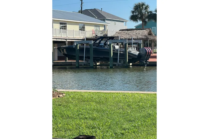  Yacht Photos Pics 2020 Midnight Express 37 Center Console boat docked by waterfront homes.