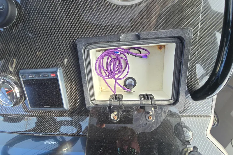  Yacht Photos Pics Carbon fiber dashboard of 2020 Midnight Express 37 Center Console with storage compartment.