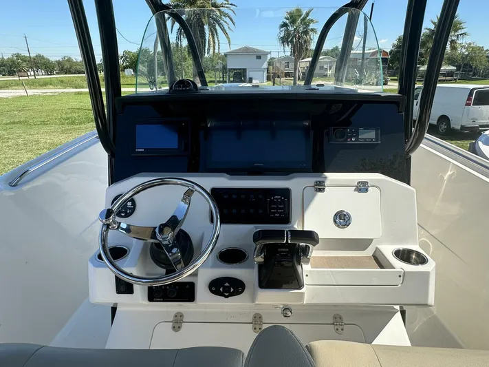 Yacht Photos Pics 2021 Sailfish 29 Center Console boat dashboard with steering wheel and navigation screens.
