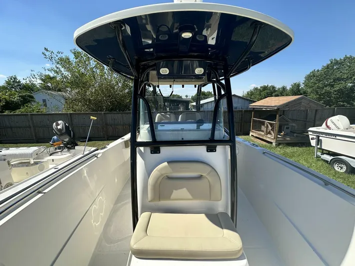  Yacht Photos Pics 2021 Sailfish 29 Center Console boat with seating and canopy, parked outdoors.
