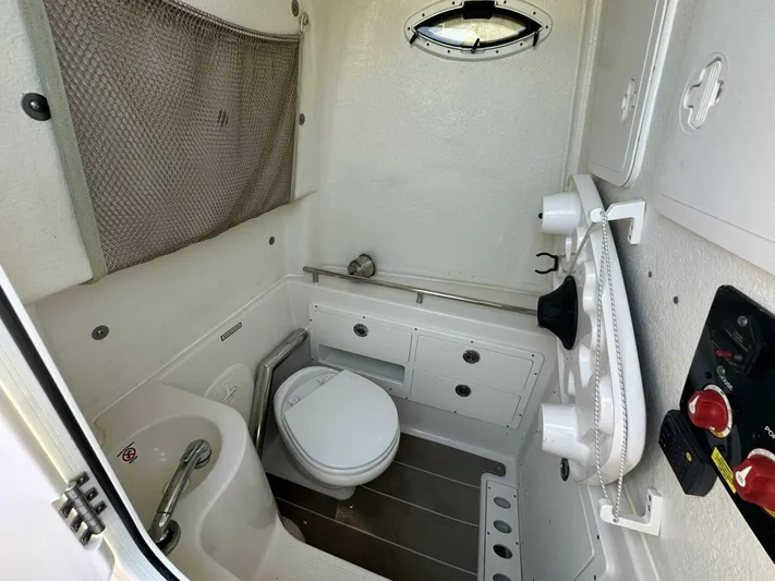  Yacht Photos Pics 2021 Sailfish 29 Center Console boat bathroom with toilet and storage compartments.