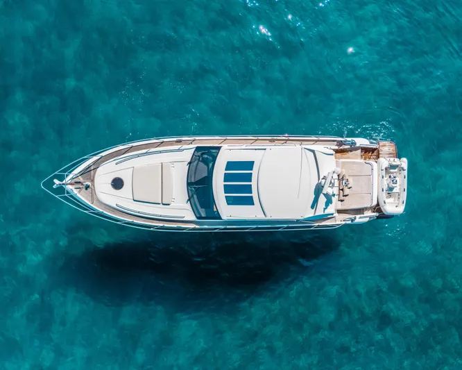  Yacht Photos Pics Aerial view of 2011 Princess V62 yacht on clear blue water.