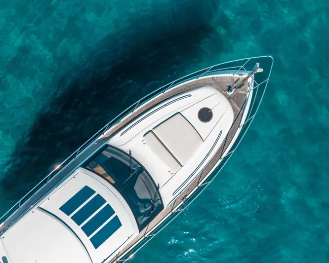  Yacht Photos Pics Aerial view of 2011 Princess V62 yacht on clear turquoise water.