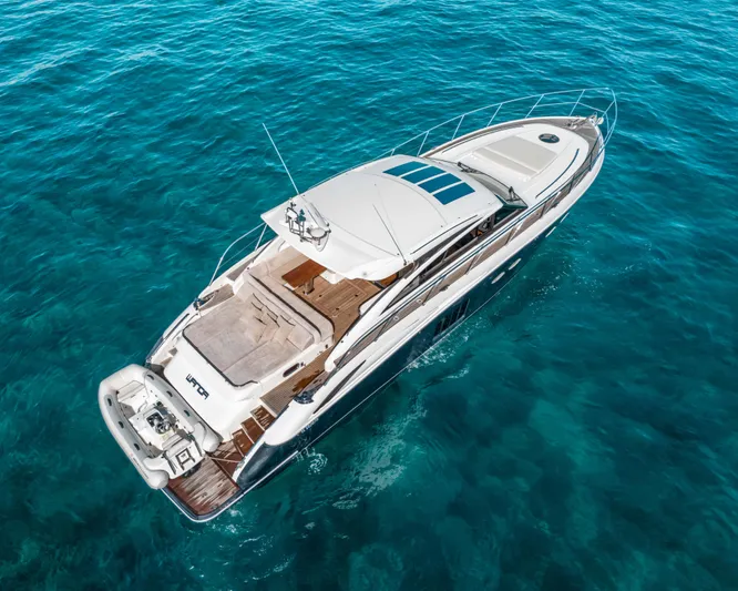  Yacht Photos Pics Luxury 2011 Princess V62 yacht cruising on clear blue ocean waters.