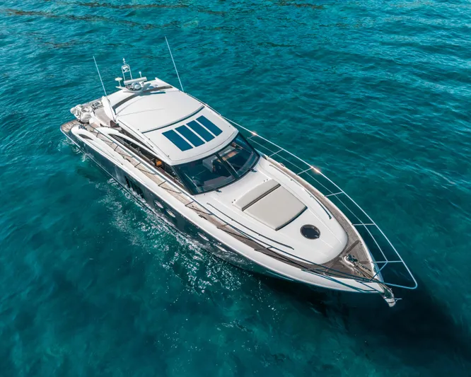  Yacht Photos Pics Luxury 2011 Princess V62 yacht cruising on clear blue waters.