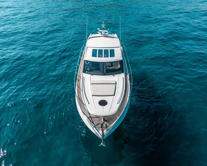  Yacht Photos Pics Luxurious 2011 Princess V62 yacht cruising on clear blue waters.