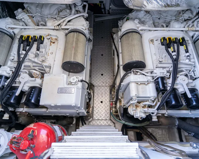  Yacht Photos Pics Engine room of a 2011 Princess V62 yacht, featuring dual engines and a fire extinguisher.