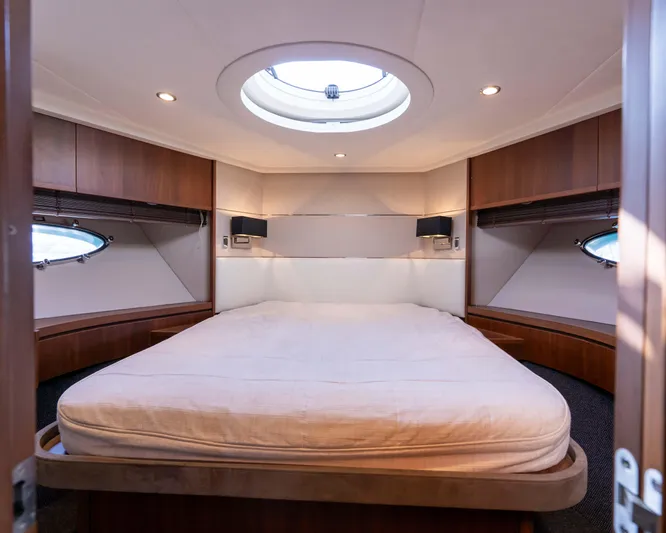  Yacht Photos Pics Luxurious cabin interior of 2011 Princess V62 yacht with circular skylight and elegant wood finishes.