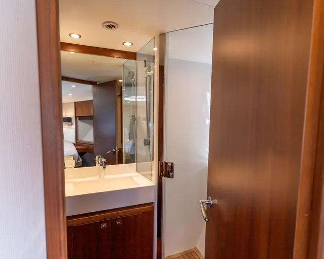  Yacht Photos Pics Luxurious bathroom interior of 2011 Princess V62 yacht with modern fixtures and wooden accents.