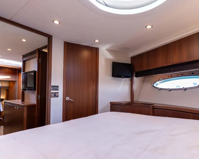  Yacht Photos Pics Luxurious 2011 Princess V62 yacht bedroom with wood paneling and modern amenities.