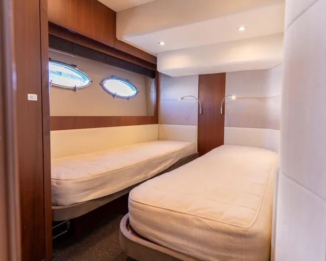  Yacht Photos Pics Luxurious twin cabin interior on 2011 Princess V62 yacht, featuring modern design and cozy lighting.