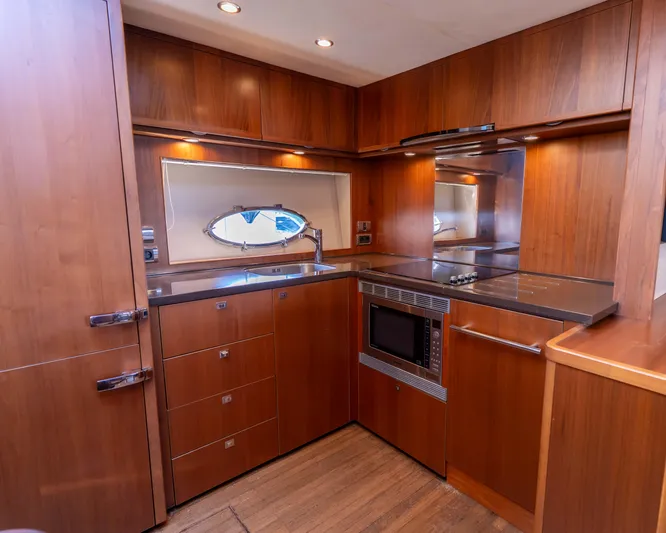  Yacht Photos Pics Luxurious wooden kitchen interior on 2011 Princess V62 yacht, featuring modern appliances.