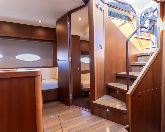  Yacht Photos Pics Luxurious interior of 2011 Princess V62 yacht with wooden finishes and elegant staircase.