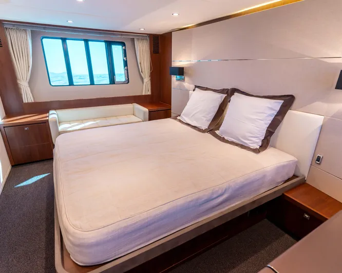  Yacht Photos Pics Luxurious bedroom interior on a 2011 Princess V62 yacht, featuring a large bed and window view.