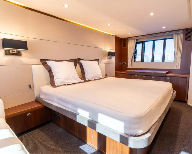  Yacht Photos Pics Luxurious bedroom interior of 2011 Princess V62 yacht with elegant furnishings and large window.