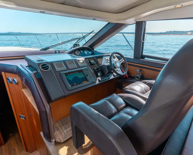  Yacht Photos Pics Luxurious 2011 Princess V62 yacht cockpit with leather seating and advanced navigation controls.