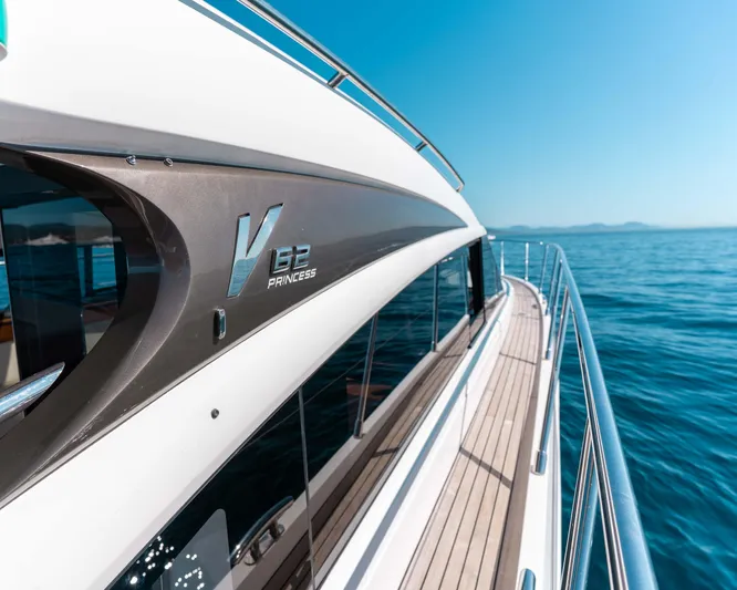  Yacht Photos Pics 2011 Princess V62 yacht cruising on open sea under clear blue sky.