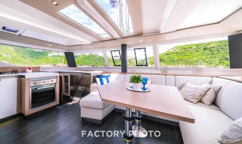 Bonova Yacht Photos Pics Luxurious interior of 2022 Fountaine Pajot Tanna 47 yacht with modern kitchen and seating area.