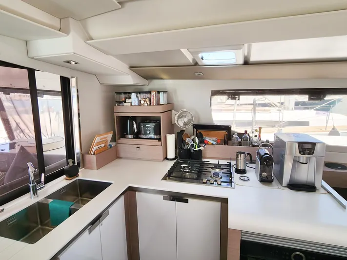 Bonova Yacht Photos Pics Modern kitchen interior of 2022 Fountaine Pajot Tanna 47 catamaran with appliances and sleek design.