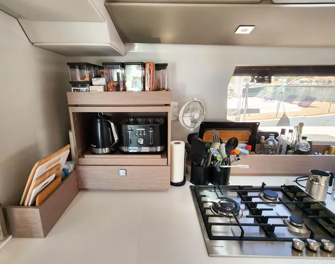 Bonova Yacht Photos Pics Modern kitchen in 2022 Fountaine Pajot Tanna 47 yacht with appliances and utensils.