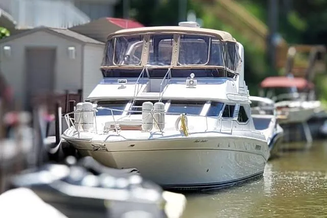 Basic Instinct Yacht Photos Pics 1995 Sea Ray 440 Express Bridge yacht docked in a marina.
