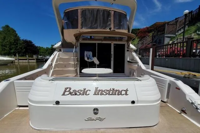 Basic Instinct Yacht Photos Pics 1995 Sea Ray 440 Express Bridge yacht named "Basic Instinct" docked at marina.