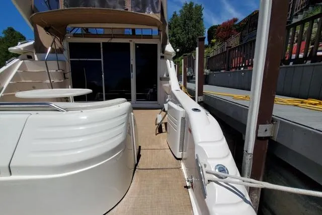 Basic Instinct Yacht Photos Pics 1995 Sea Ray 440 Express Bridge yacht docked, showcasing spacious deck and sleek design.