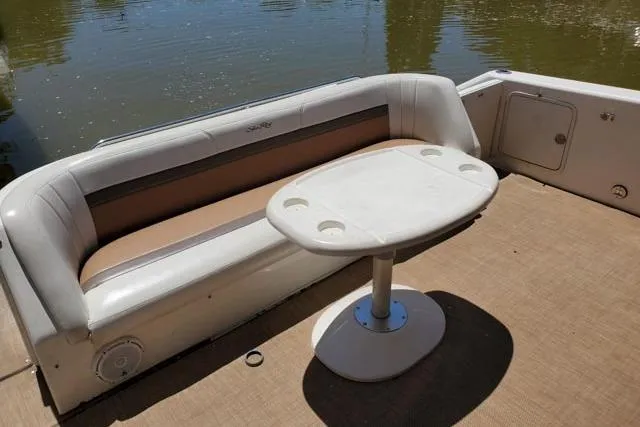 Basic Instinct Yacht Photos Pics 1995 Sea Ray 440 Express Bridge boat interior with seating and table by the water.