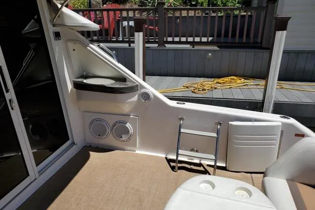 Basic Instinct Yacht Photos Pics 1995 Sea Ray 440 Express Bridge interior with seating, ladder, and deck view.