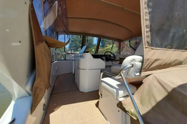 Basic Instinct Yacht Photos Pics 1995 Sea Ray 440 Express Bridge interior with tan canopy and helm station.
