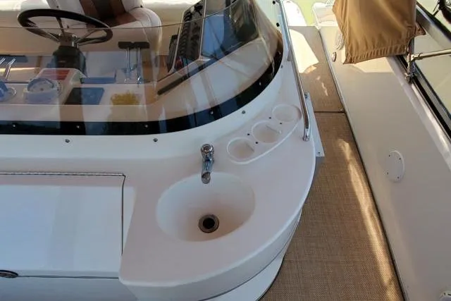 Basic Instinct Yacht Photos Pics 1995 Sea Ray 440 Express Bridge helm with sink and cup holders.