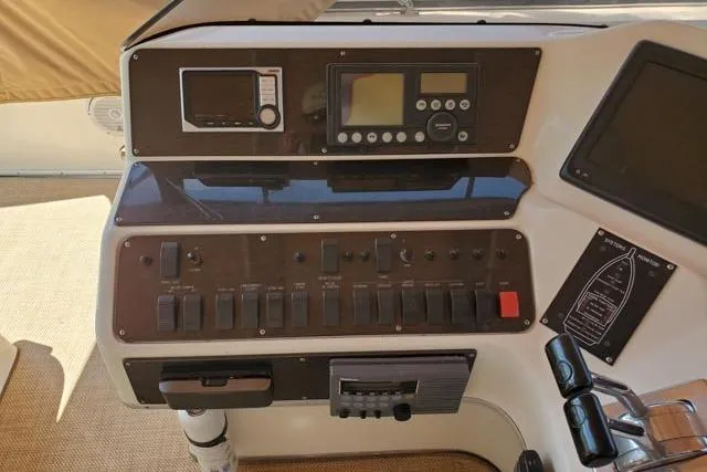 Basic Instinct Yacht Photos Pics Control panel of a 1995 Sea Ray 440 Express Bridge yacht, featuring navigation and control switches.