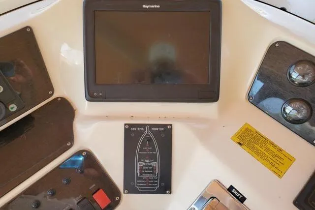 Basic Instinct Yacht Photos Pics Control panel of a 1995 Sea Ray 440 Express Bridge with Raymarine display.